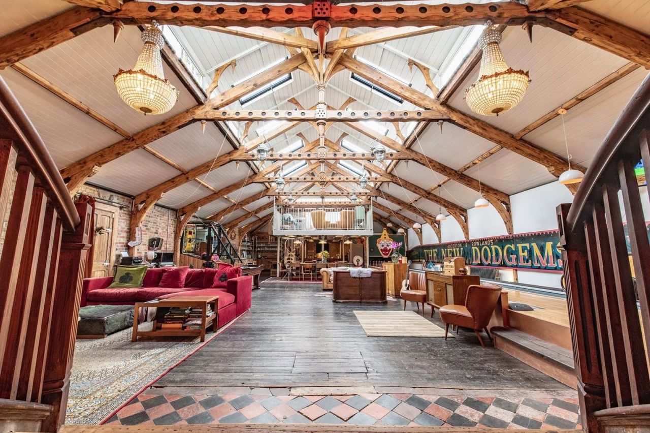 A large open plan living room with V-shape timber roof structure