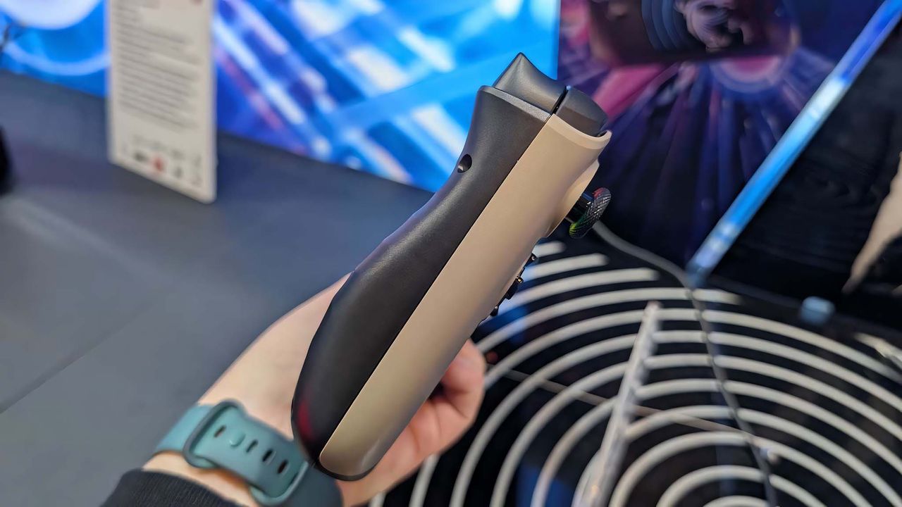 MSI Claw 8 AI+ being held in a hand so that you can see its ergonomic profile.