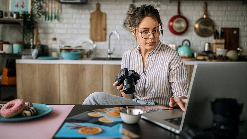 A photographer learning how to edit photos on her laptop