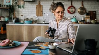 A photographer learning how to edit photos on her laptop