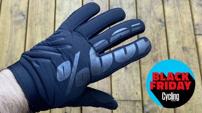 Brisker winter gloves warn showing the 100% logo across two fingers and the hand, alongside the Cycling Weekly Black Friday Bike deals roundel.