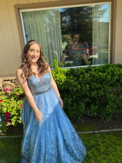 Annette Barranco models her prom dress outside her grandparents' house.