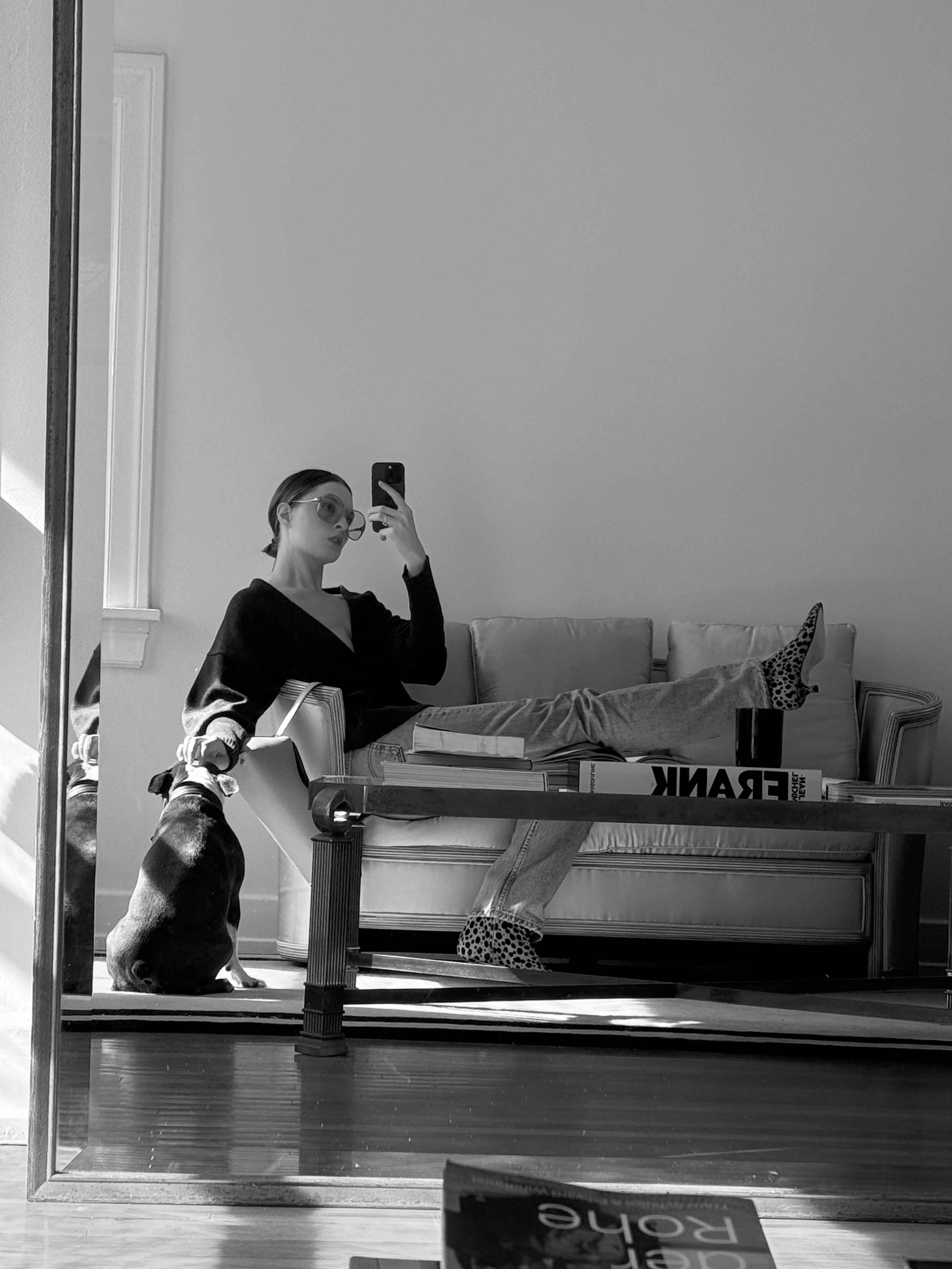 A black and white image of Christie Tyler wearing white trousers and a blak sweater.