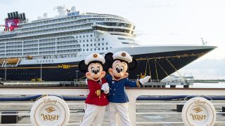 Mickey and Minnie in front of the Disney Wish