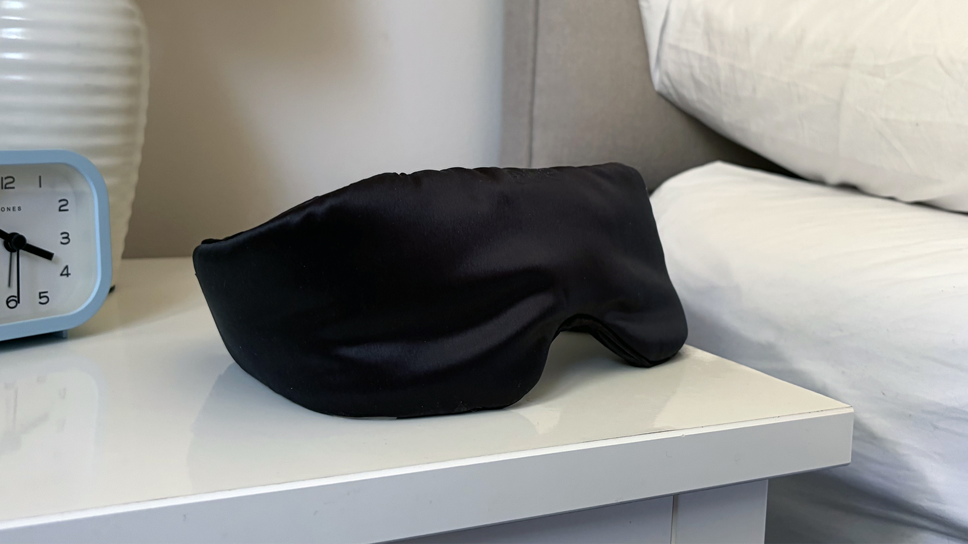 A close up of the SilkSound Sleep Mask on the nightstand in our reviewer's bedroom
