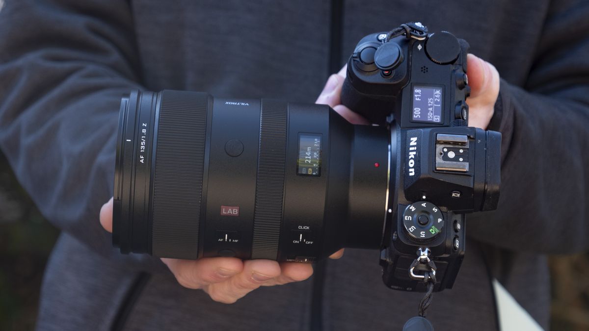 Viltrox 135mm F1.8 Lab lens for Nikon Z-mount, in the hand, attached to a Nikon Z6 II