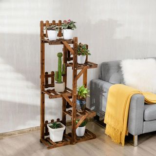 Dark brown wooden shelves with potted plants on top