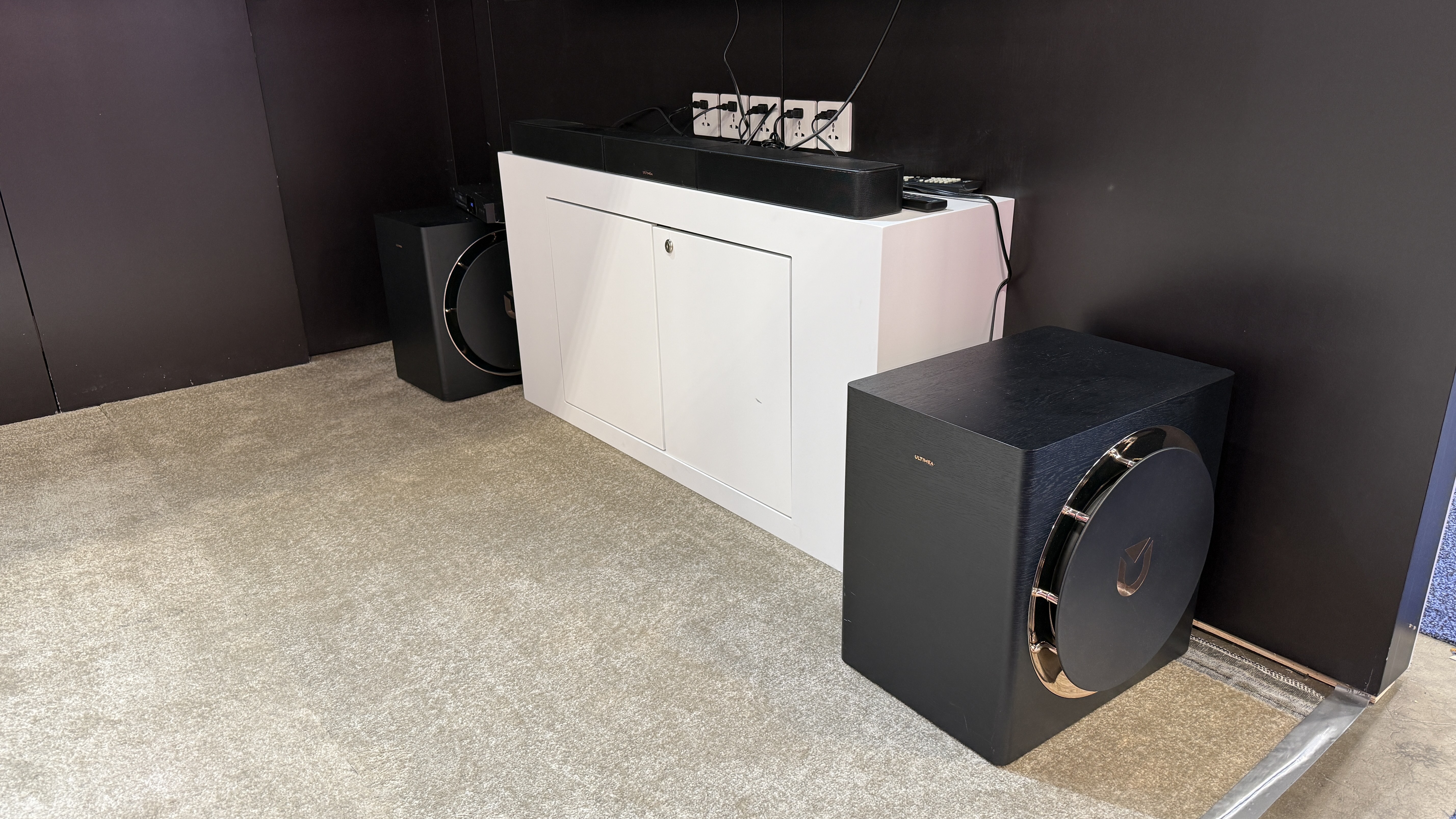 The Ultimea Skywave X100 Dual at CES 2026 on the show floor, showing the two subs and a soundbar