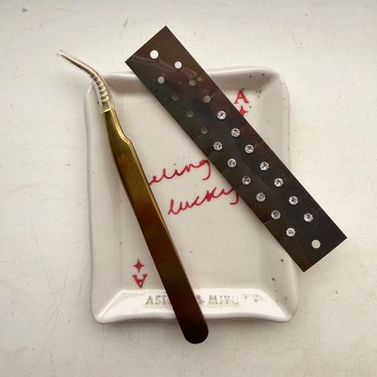 At home acupressure: Health writer Ash S with at home ear seeds, acupressure mat, and more