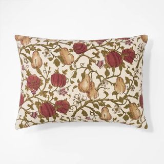 A patterned orange and red throw pillow from Studio McGee's Target collection