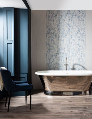 classic bathroom with roll top bath, floral tile focal wall, navy painted woodwork and window
