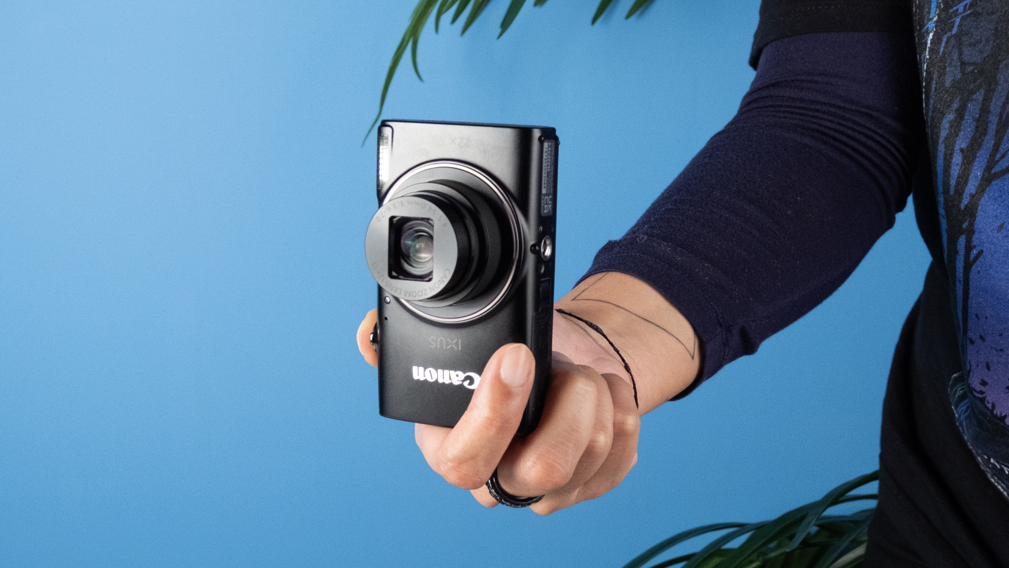 A black Canon PowerShot Elph 360 HS A or Canon PowerShot IXUS 285 HS A compact camera