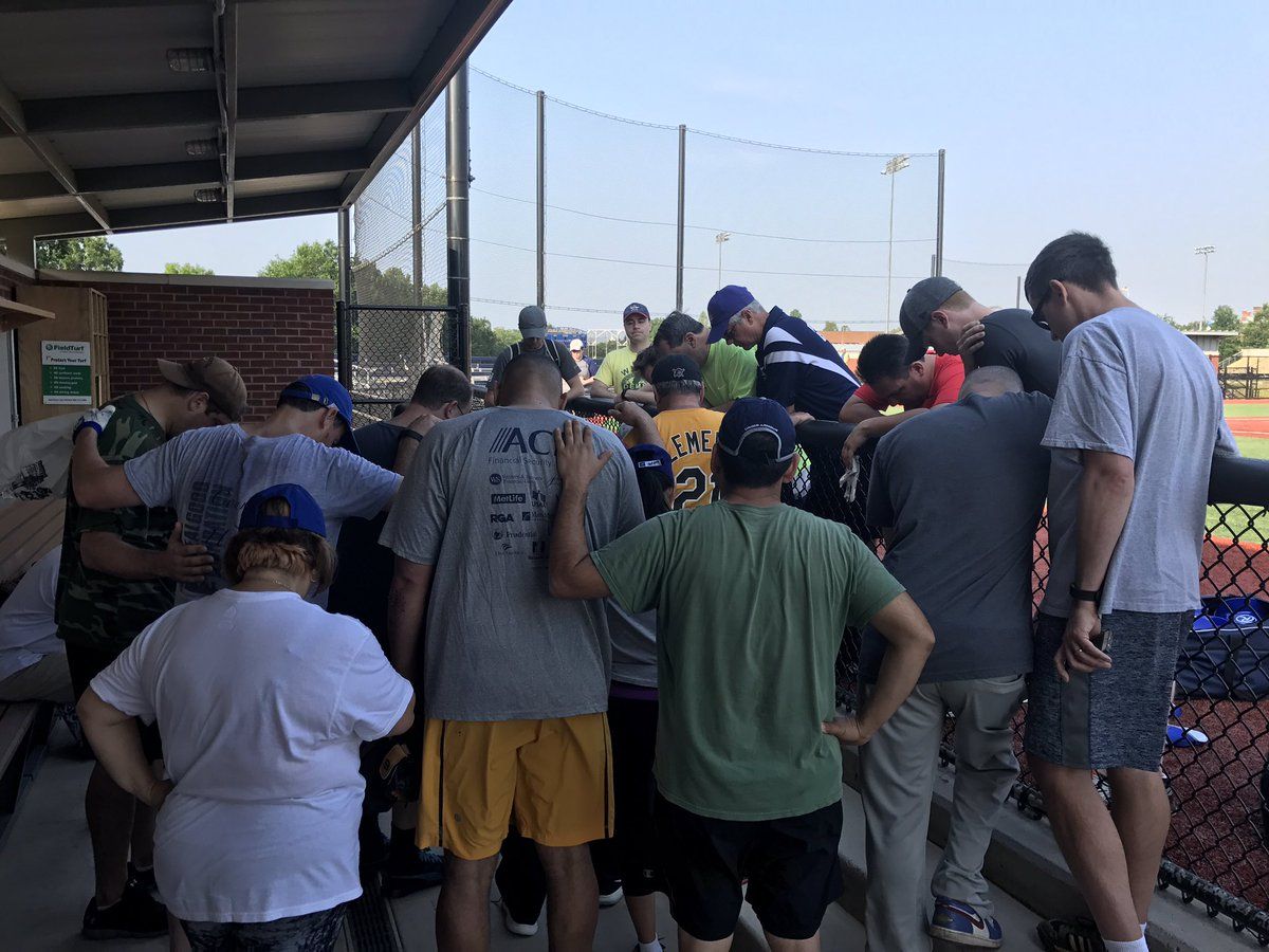 House Democrats praying on baseball field.