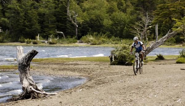 A racer along a lake in stage 4 of the Trans Andes