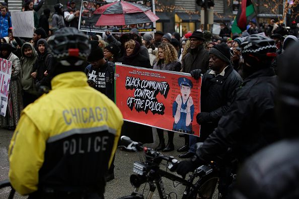 Demonstrators protest the fatal shooting of Laquan McDonald along Chicago&amp;#039;s Magnificent Mile 