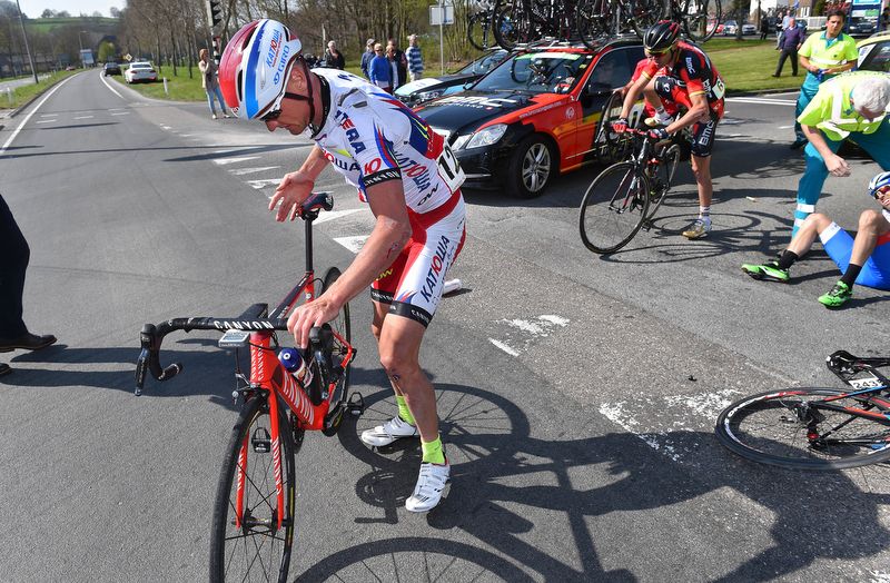 Sergey Lagutin (Katusha) tries to get back on his bike with bloodied hands