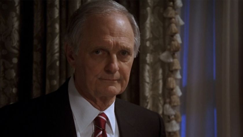 Alan Alda in a suit, looking very serious on The West Wing