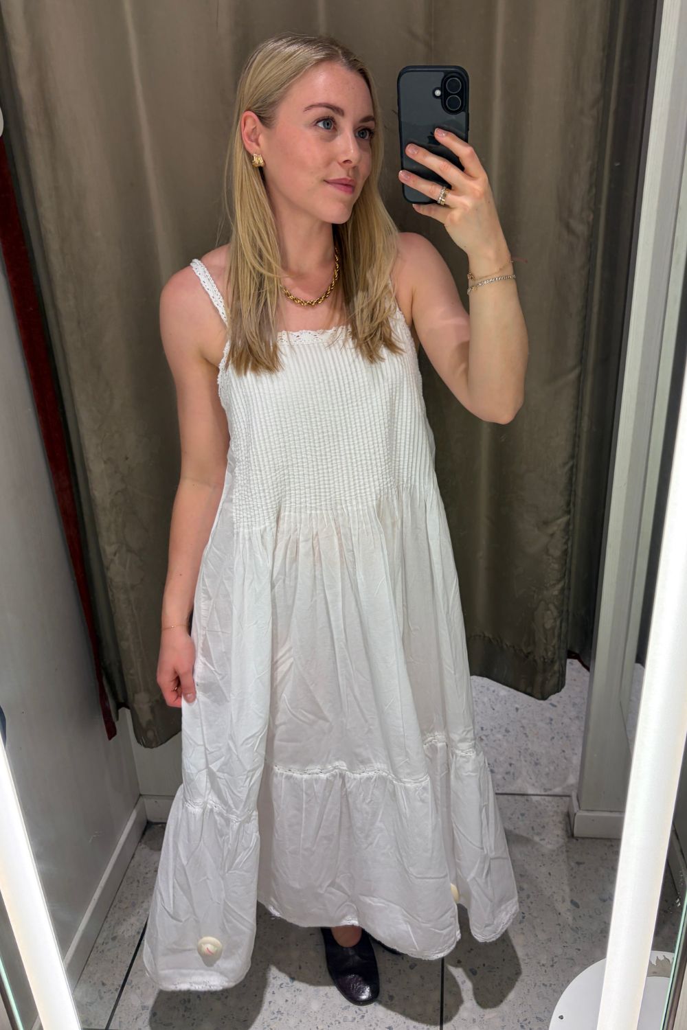 Woman wears a white H&amp;amp;M dress