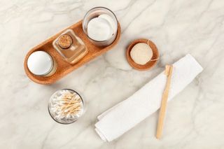 Sustainable toiletries. Homemade lotions, cotton pads, bamboo toothbrush, natural Konjac sponge, and biodegradable bamboo cotton