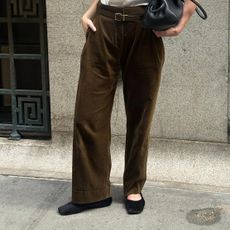 Influencer wearing brown pants with calf hair flats