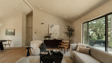 living room with neutral walls and furniture and a black coffee table