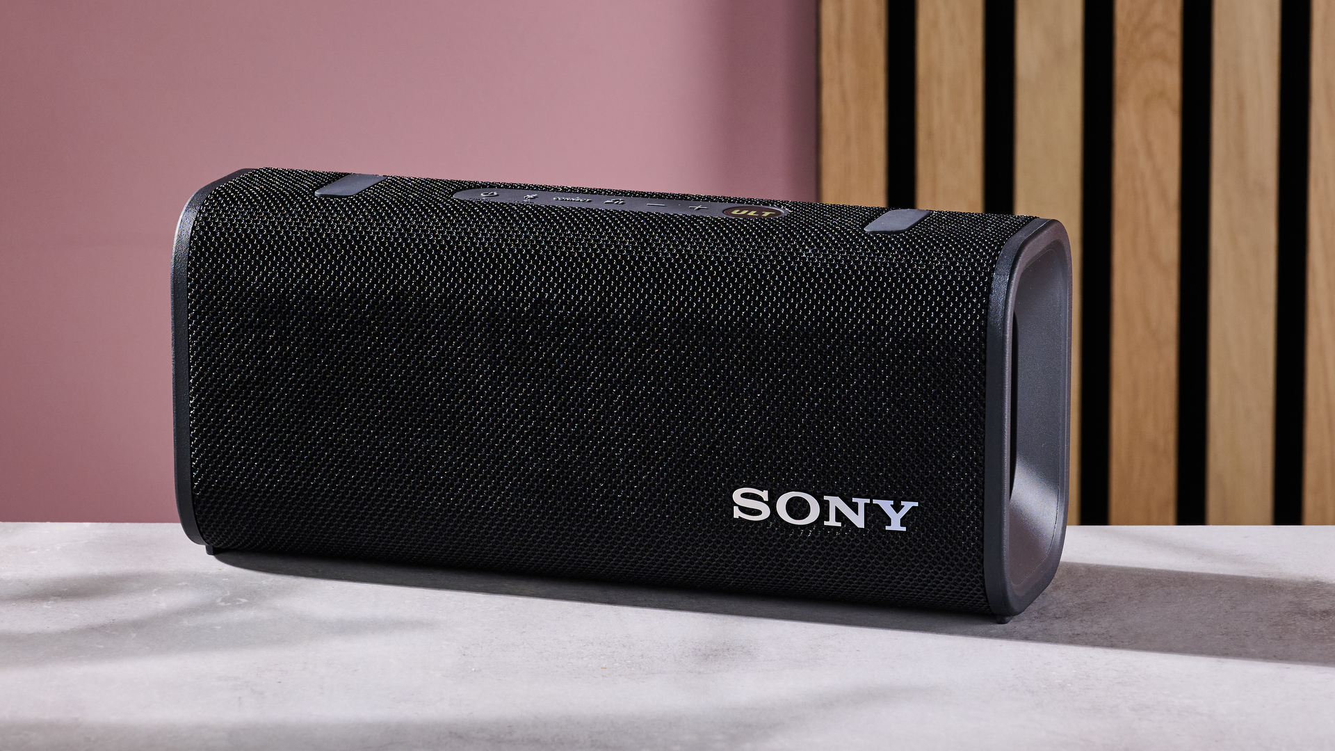 Sony ULT Field 3 on table against pink background
