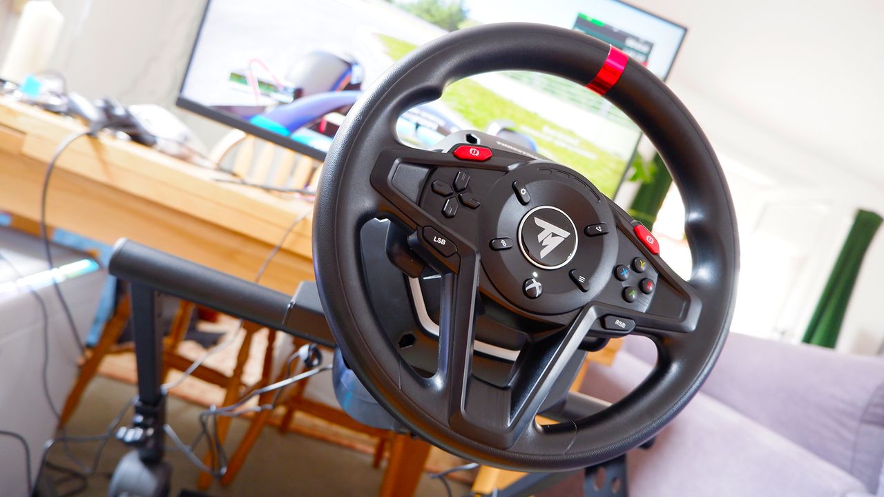The Thrustmaster T128 racing wheel mounted on a Monoprice stand.