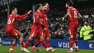 Liverpool's Egyptian striker #11 Mohamed Salah celebrates scoring the team's second goal during the English Premier League football match between Everton and Liverpool at Goodison Park in Liverpool, north west England on February 12, 2025. 