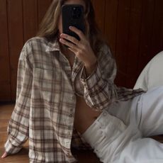 Angie wears a check skirt, white jeans