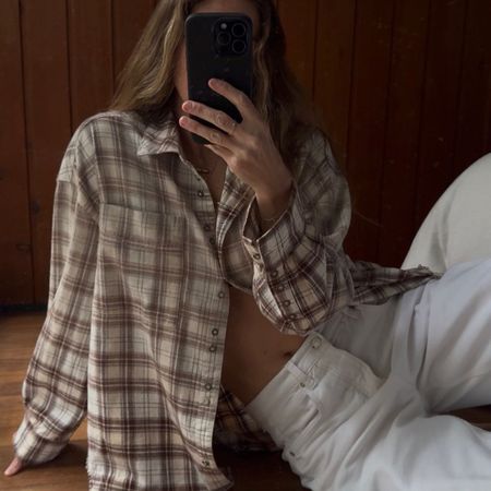 Angie wears a check skirt, white jeans
