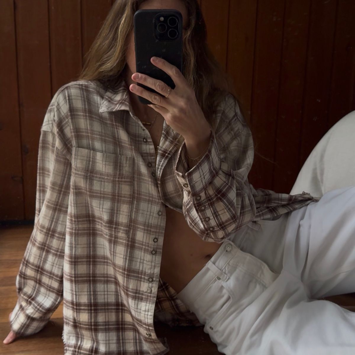 Angie wears a check skirt, white jeans