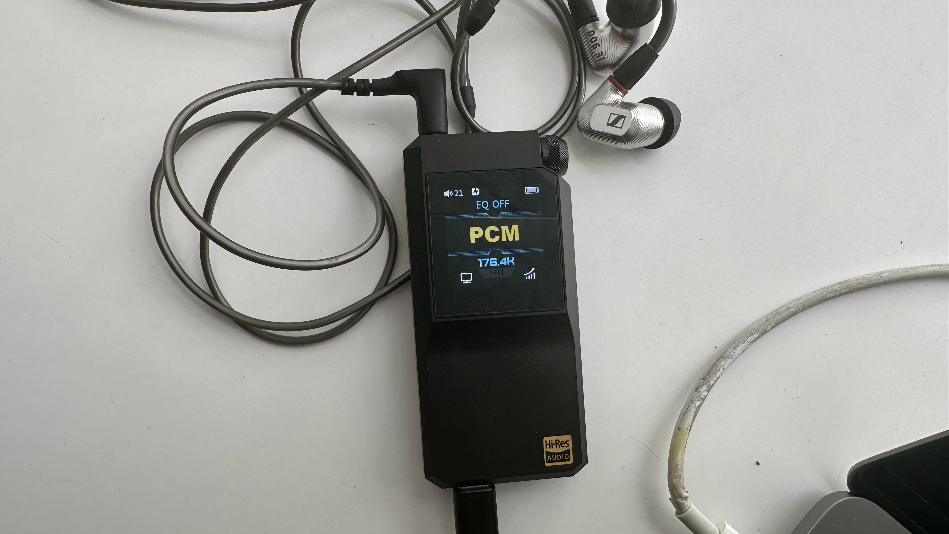 FiiO&#039;s BTR17 DAC/amp in black, on a gray table, showing PCM resolution in yellow font
