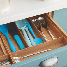 blue plastic cooking utensils inside a drawer