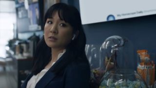 Constance Wu in the office, looking to the side with a face of concern in The Terminal List.