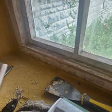 wooden windows with paint stripped and scraped off