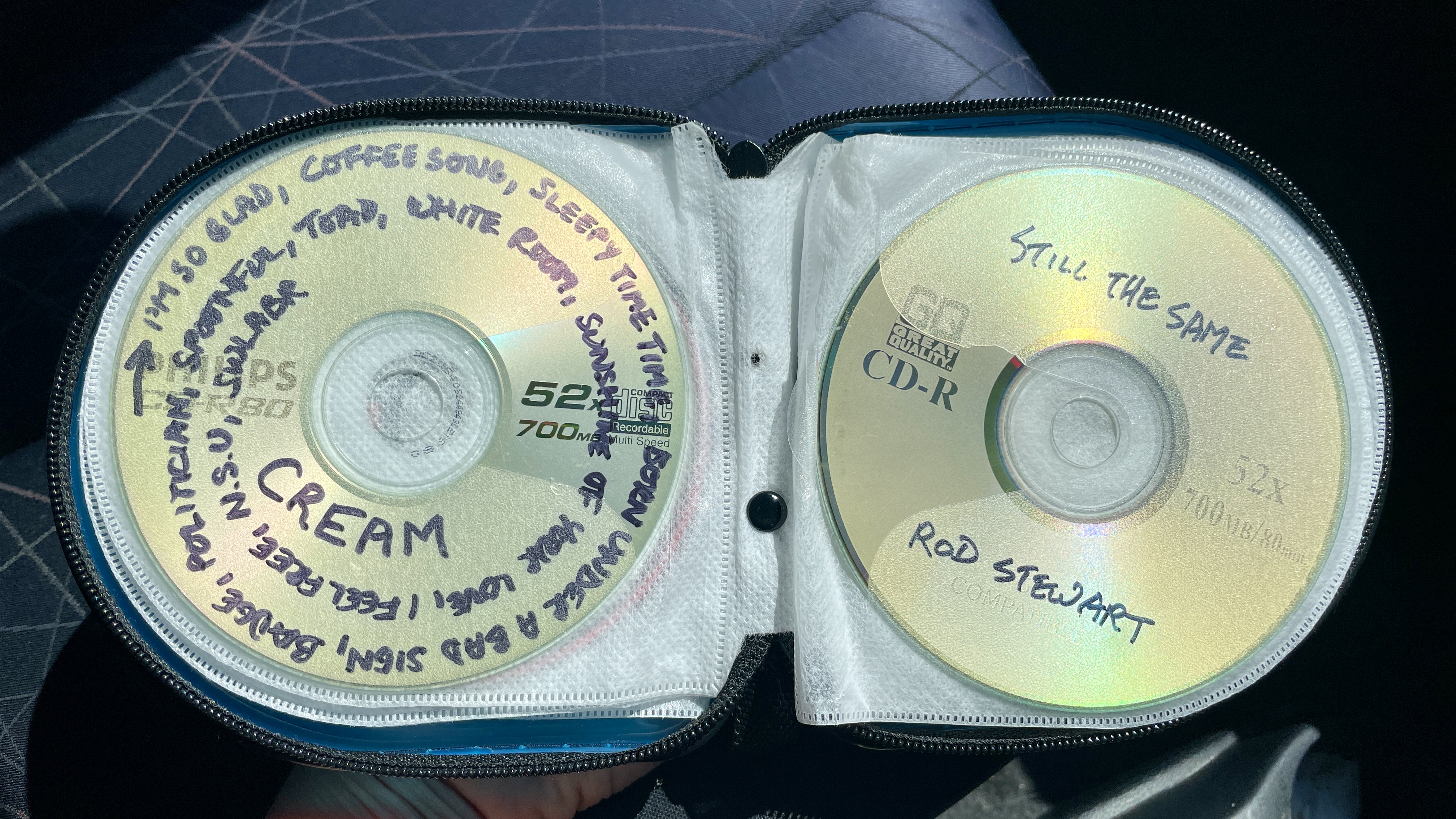 A car's CD player and burned CDs, on a hot day
