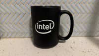 Black Intel mug on a white countertop.