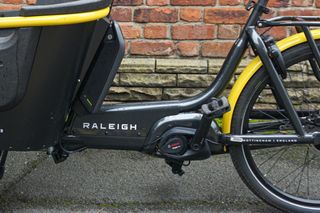 The Raleigh Stride 2 e-Cargo bike comes with a Bosch e-cargo line battery and motor which is shown close up in the image