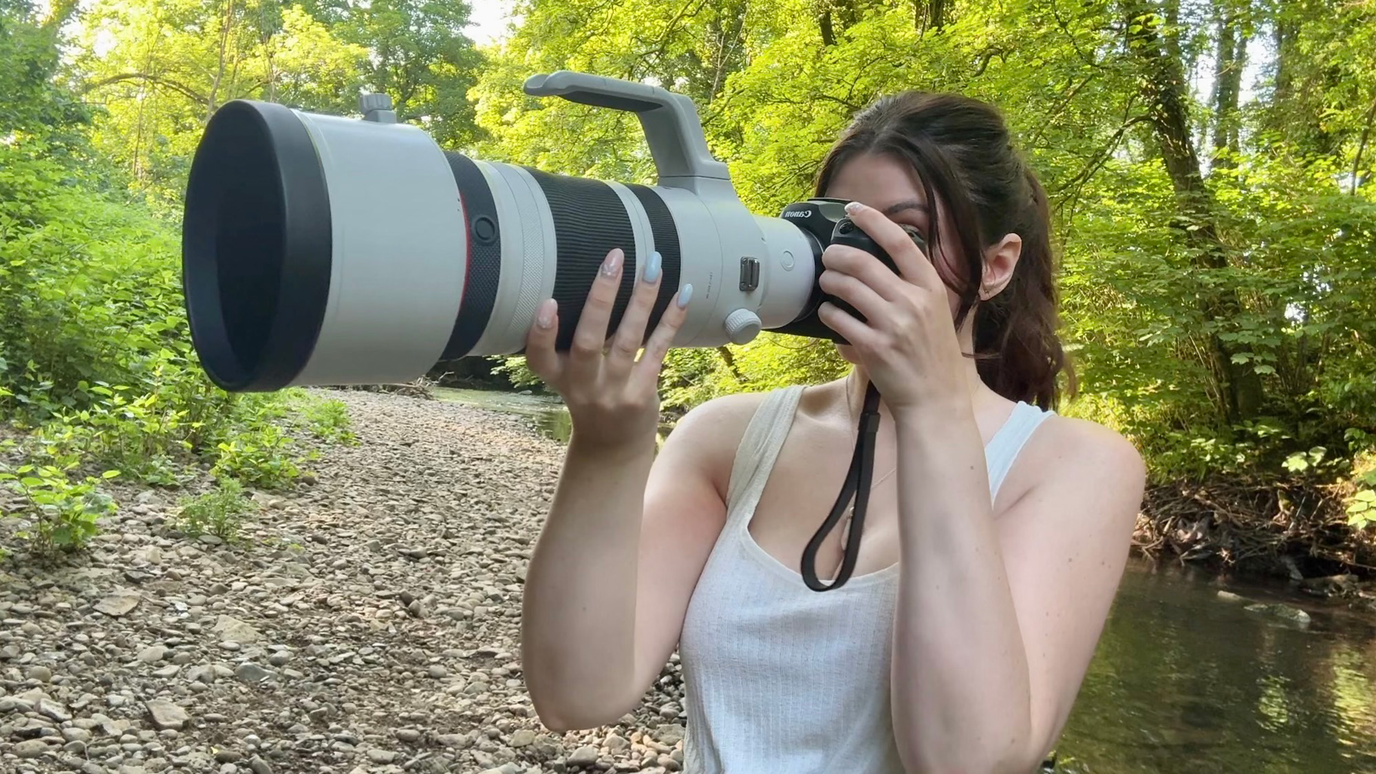 author Kimberley Lane using the Canon R6 III and Canon RF 100-300mm f/2.8L IS USM lens in a wooded area