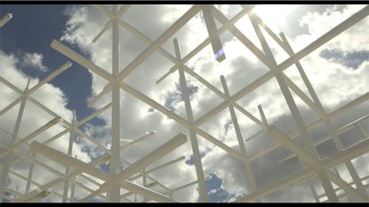 Sou Fujimoto's Serpentine Gallery Pavilion being built with clouds in the background