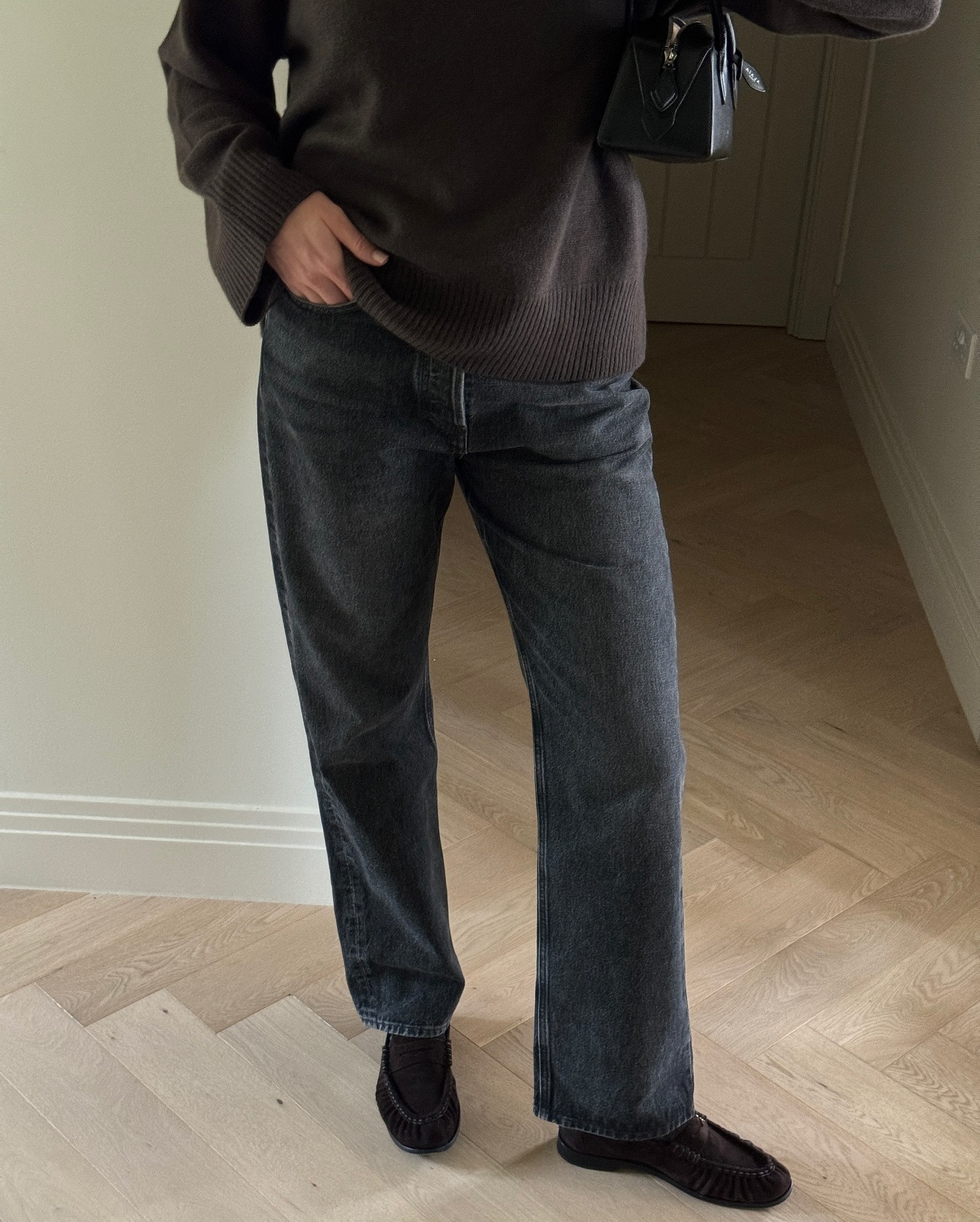 Fashion person Sarah Blyth wears a brown shoe outfit. She pairs her brown suede loafers with a dark washed jean and brown jumper in a recent image taken from her Instagram.