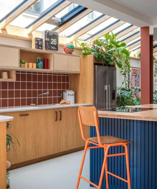 Sustainable kitchens retro kitchen with wood laminate cabinets and navy fluted island