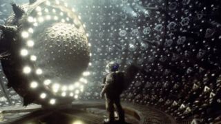 An astronaut by a giant glowing machine in the movie Event Horizon.