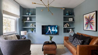living room with blue wall tv sof sets with cushions and white window