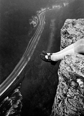 legs hanging over a rock in show for centre for british photography in london