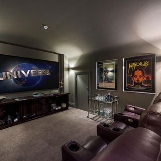 cinema room with big tv screen and grey wall