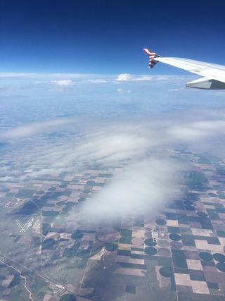 During the eclipse, clouds next to the plane appeared darker than the bright white clouds on the horizon.