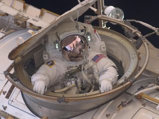 Astronaut Andrew Feustel reenters the International Space Station after completing an 8-hour, 7-minute spacewalk on Sunday, May 22, 2011, the second of four STS-134 mission spacewalks.