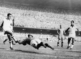 Swedish goalkeeper Kalle Svensson dives to block the ball in front of Brazilian forward Ademir 09 July 1950 in Rio de Janeiro during their World Cup final pool soccer match. Ademir scored four goals as Brazil beat Sweden 7-1. Ademir finished the competition as the leading scorer with 8 goals, but Brazil lost in the final to Uruguay (1-2) in front of 200.000 fans at Maracana stadium in Rio de Janeiro 16 July.