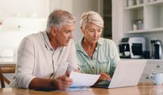 Paperwork, home and senior couple with laptop for finance planning with retirement and pension fund. Computer, documents and elderly man and woman with bank app for mortgage, bills or debt payment.